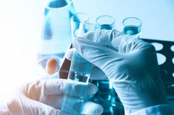 Researcher with glass laboratory chemical test tubes with liquid Premium Photo